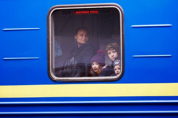 Ukrainian refugees look out of a window on a train arriving from Odesa after crossing the Ukraine-Poland border, amid the Russian invasion of Ukraine, at Przemysl Glowny train station in Przemysl, Poland, April 21, 2022